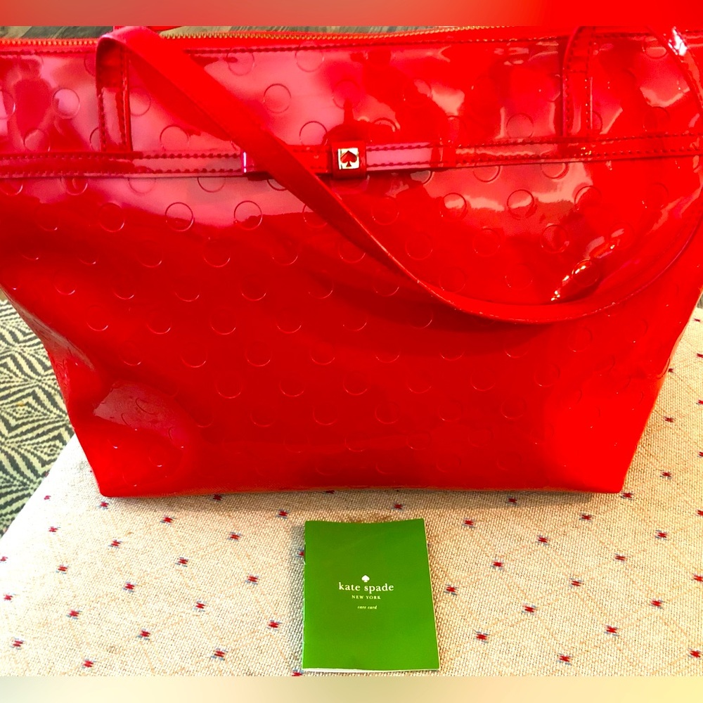 Bright red Kate Spade patent leather bag in good used condition. Wear is shown.